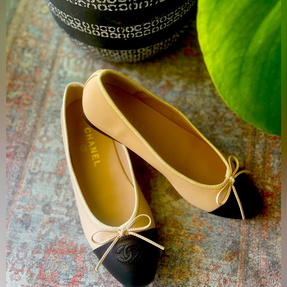 Tan and black cap toe flats